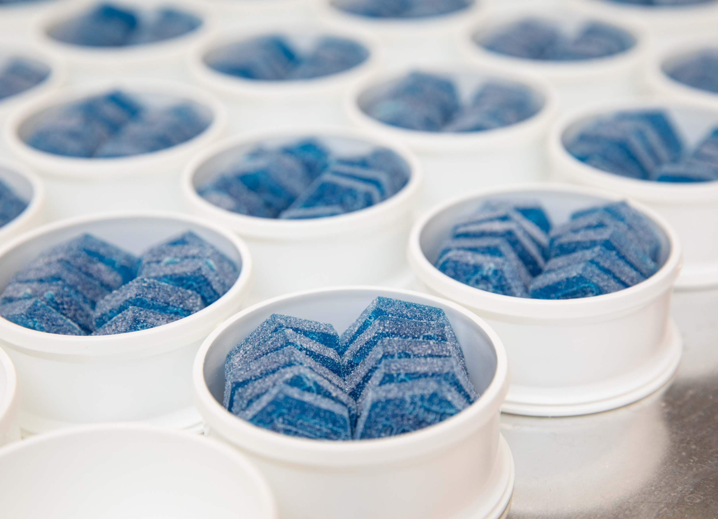 blue cannabis gummies in white dishes